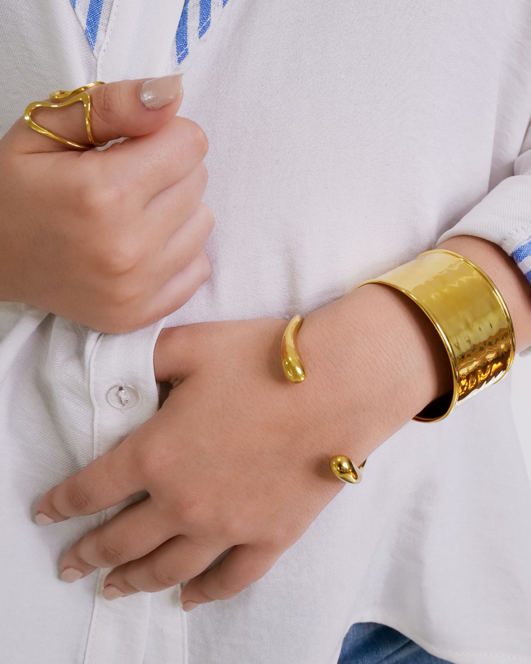layered chunky gold-plated stainless steel bangles and bold ring