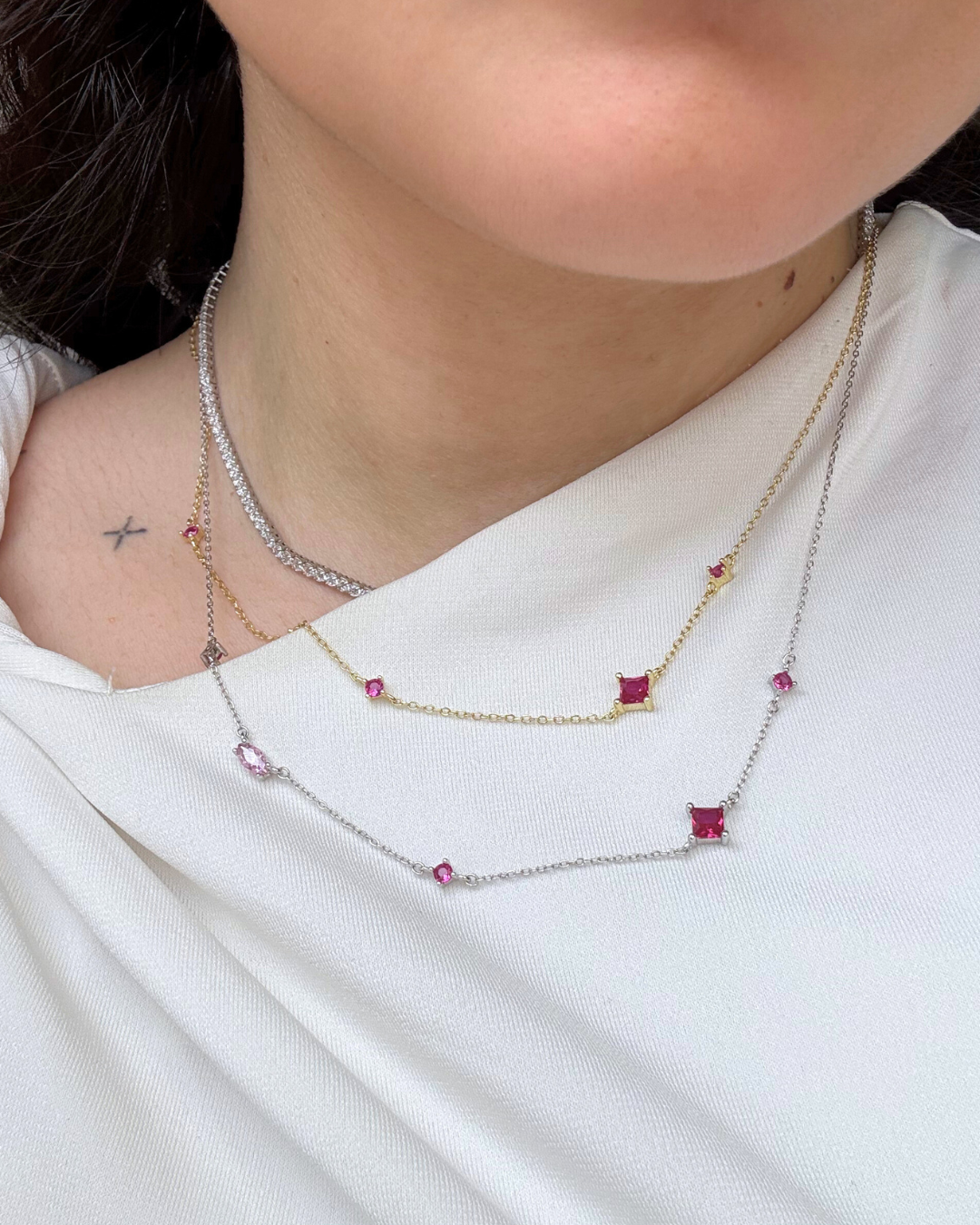 layered mixed metal silver and gold necklaces. tennis necklace and charm necklaces