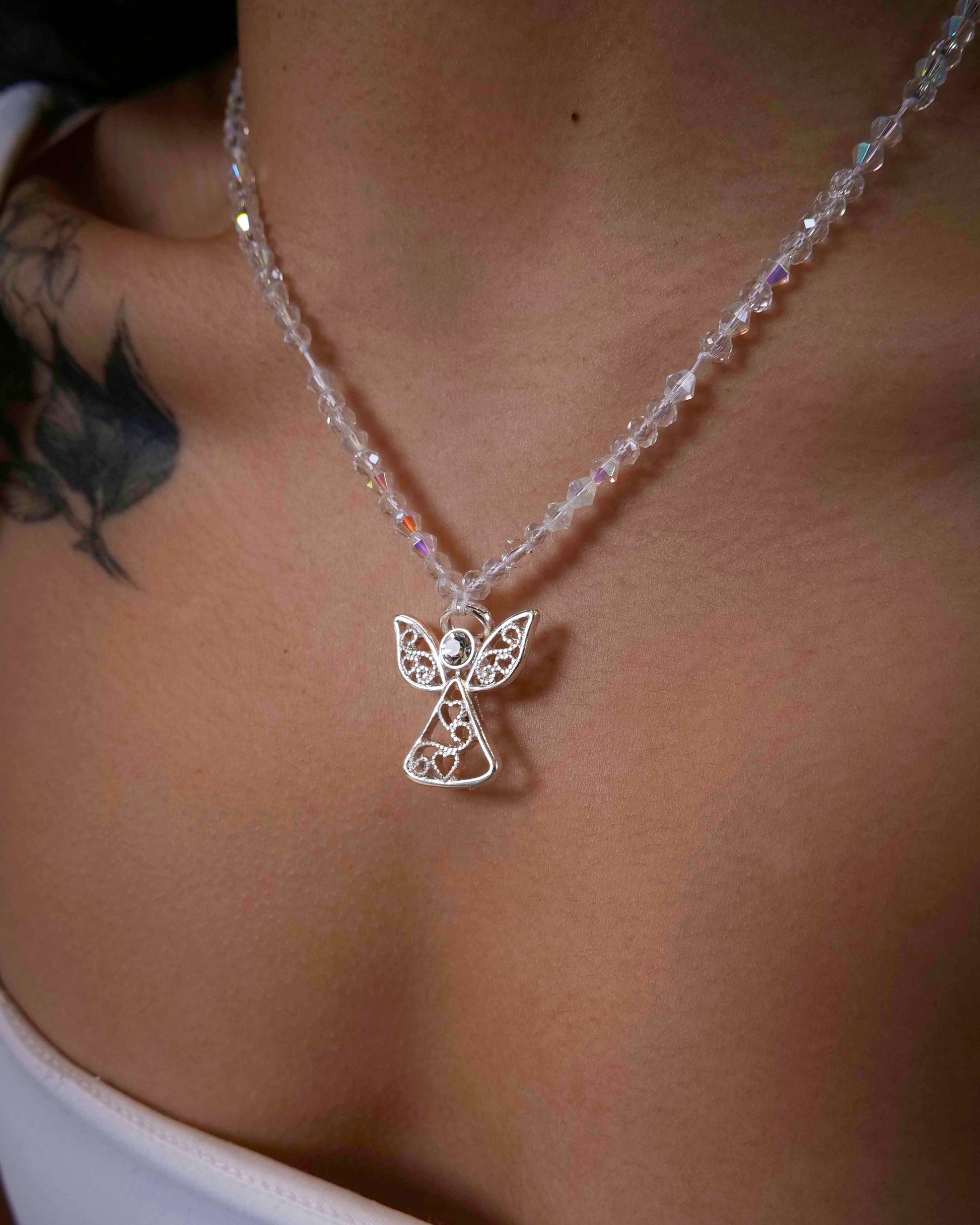 Handmade clear crystal beaded necklace with angel charm.