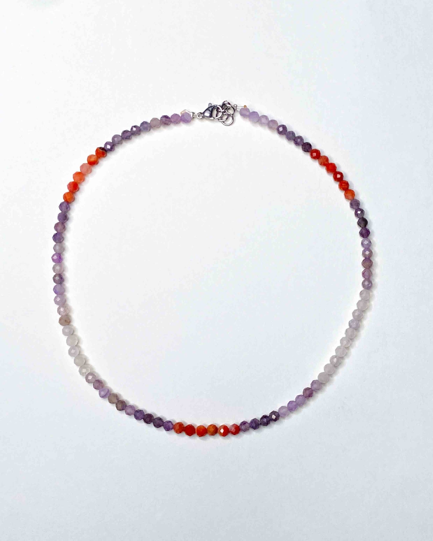 Handmade purple and orange mixed gemstone bead necklace with a sterling silver clasp.