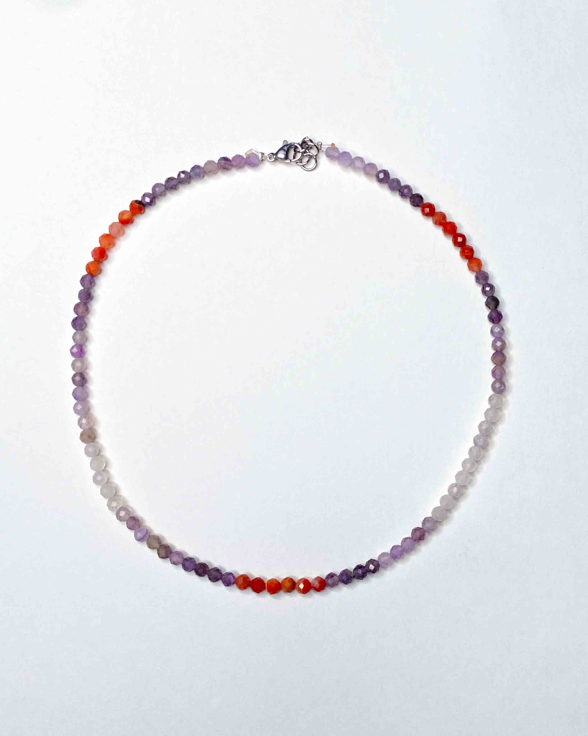 Handmade purple and orange mixed gemstone bead necklace with a sterling silver clasp.