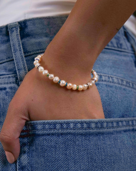 Handmade beaded fresh-water pearl bracelet with rhinestone spacers.