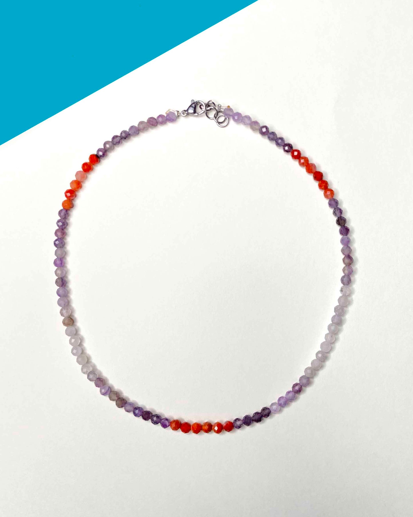 Handmade purple and orange mixed gemstone bead necklace with a sterling silver clasp.