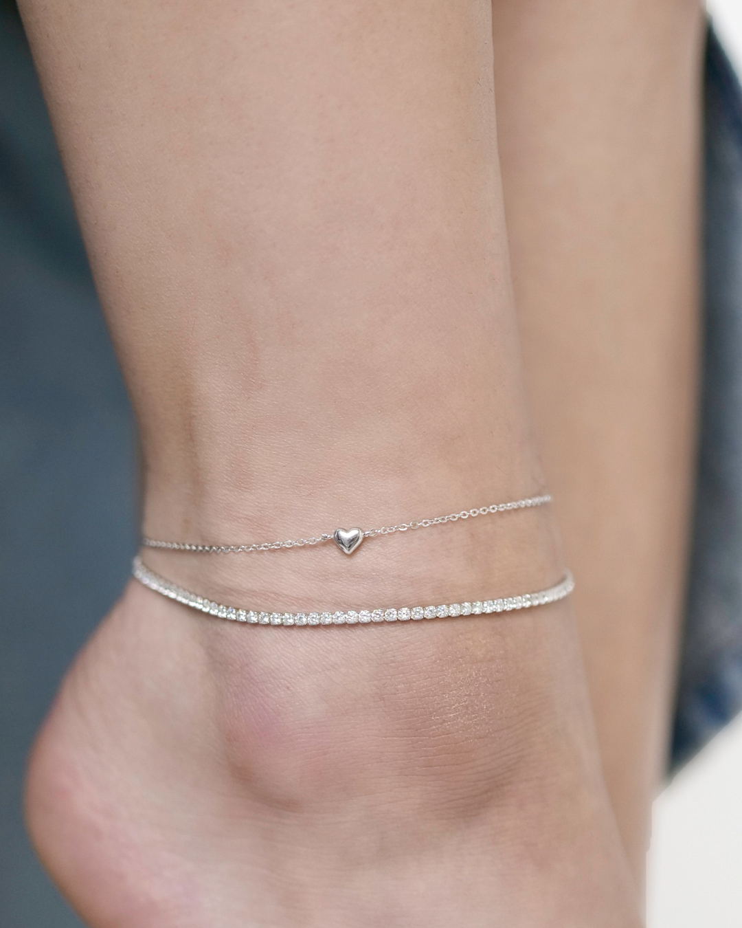 Layered sterling silver anklets. tennis anklet and heart charm anklet