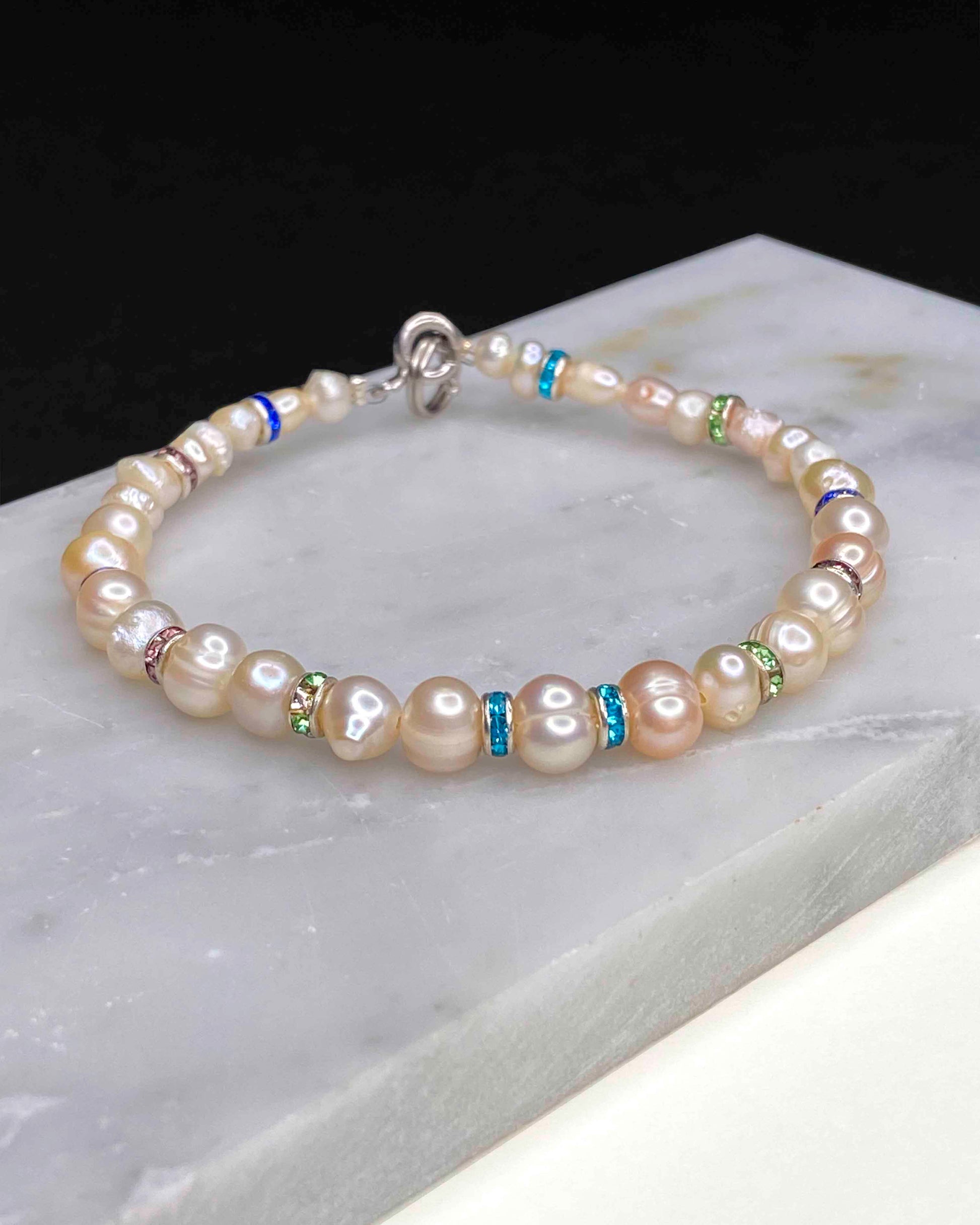 Handmade beaded pearl bracelet with rhinestone spacers.