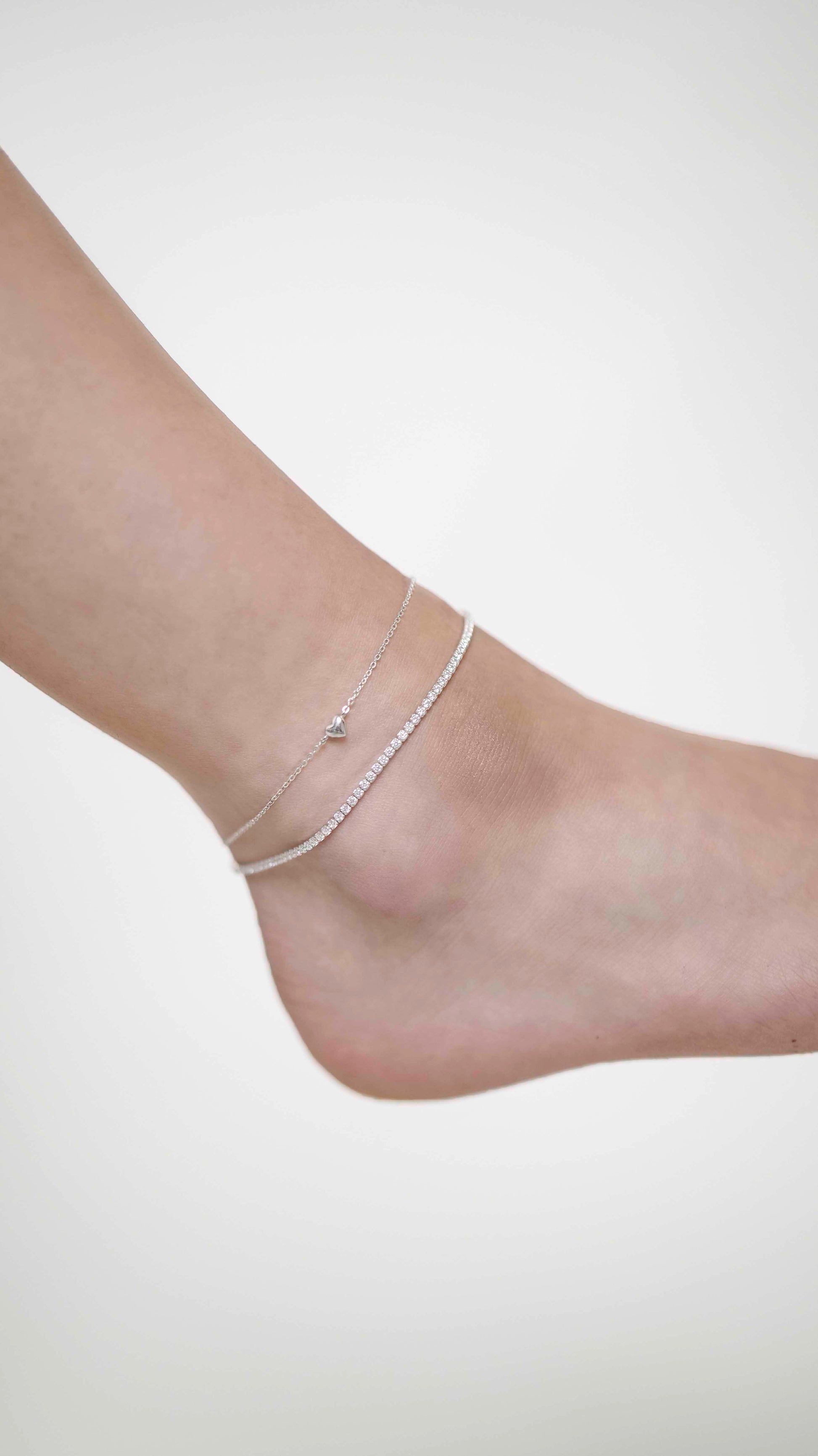 Sterling silver zirconia stone tennis anklet with heart link chain anklet.