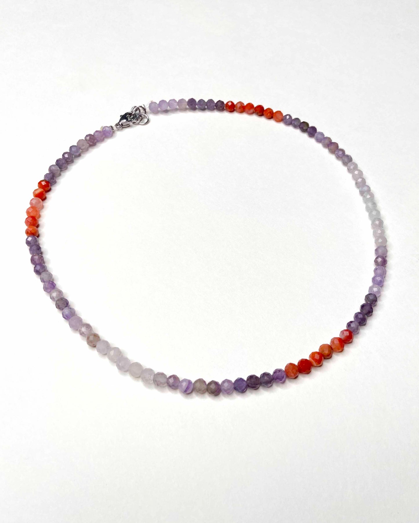 Handmade purple and orange mixed gemstone bead necklace with a sterling silver clasp.