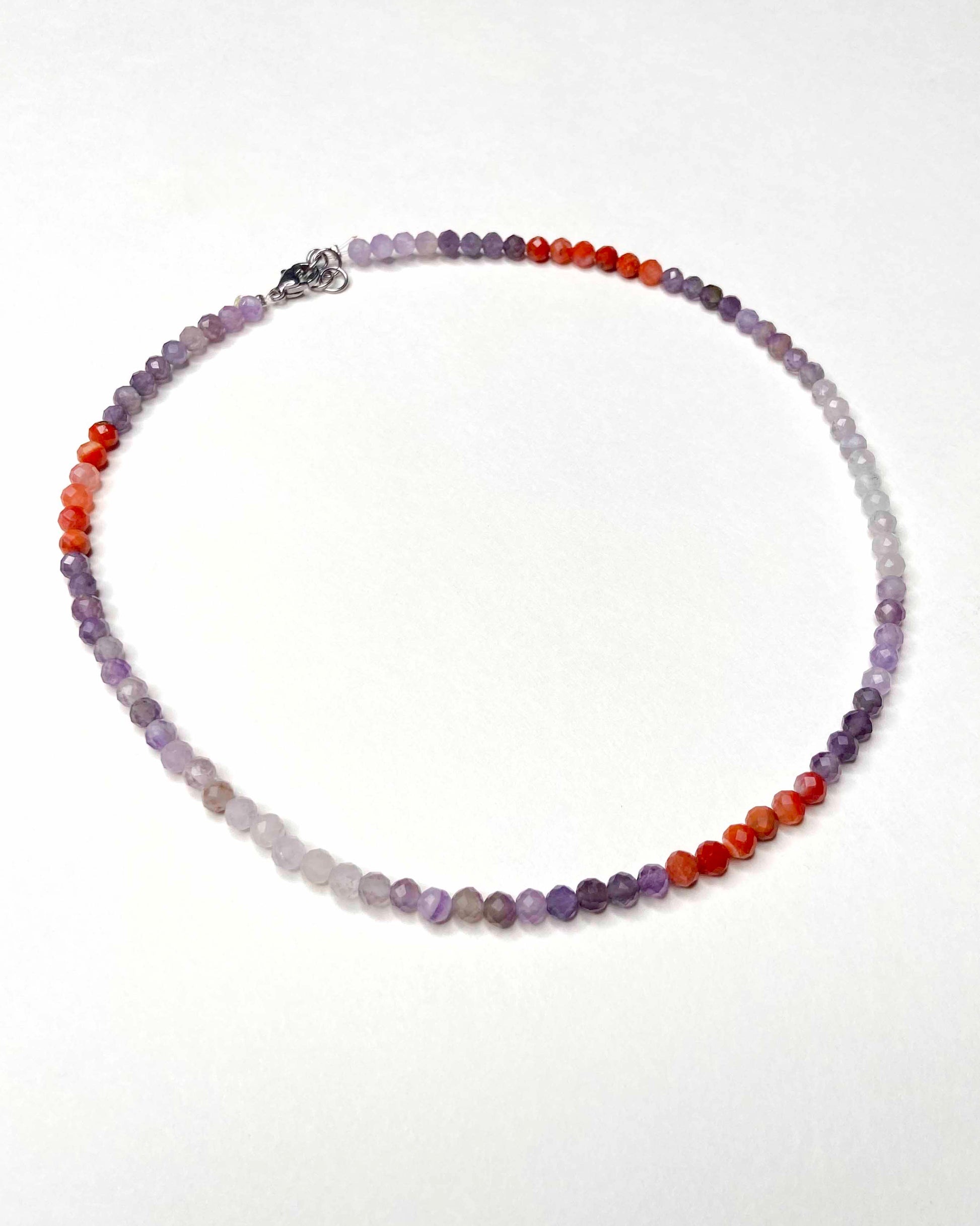 Handmade purple and orange mixed gemstone bead necklace with a sterling silver clasp.
