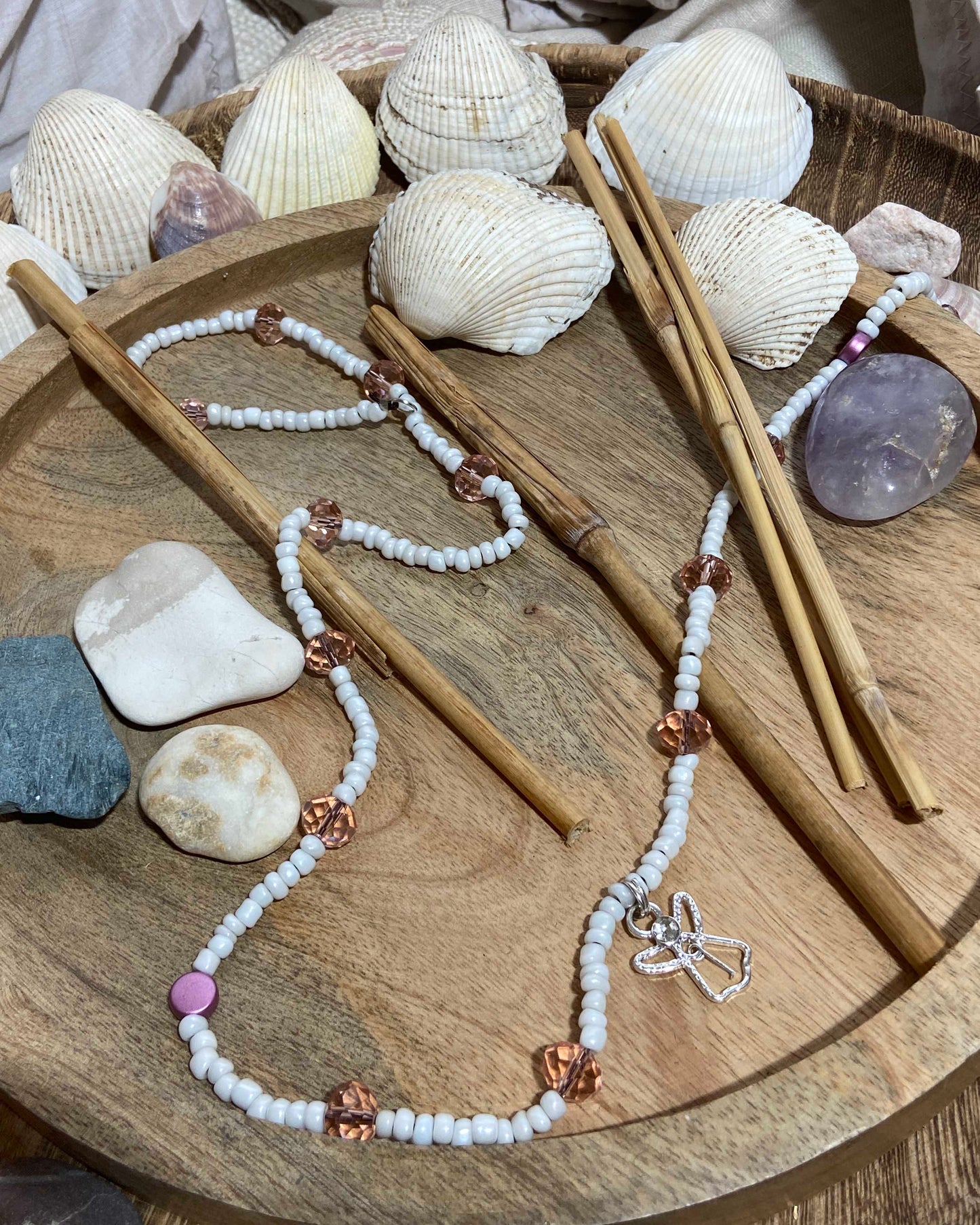 White glass beads with large light pink crystal and circle beads, handcrafted into a belly chain with silver angel charm