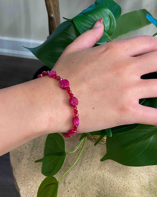 A handmade red crystal bead and pink rubellite stone bracelet.
