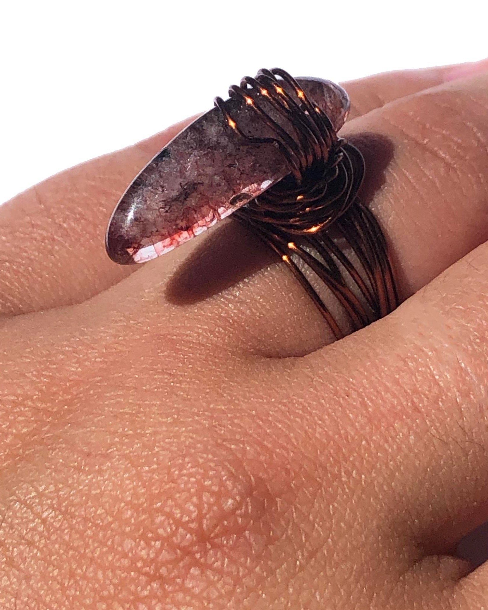 handcrafted wire wrapped ring made using brown wires and a tourmaline gemstone