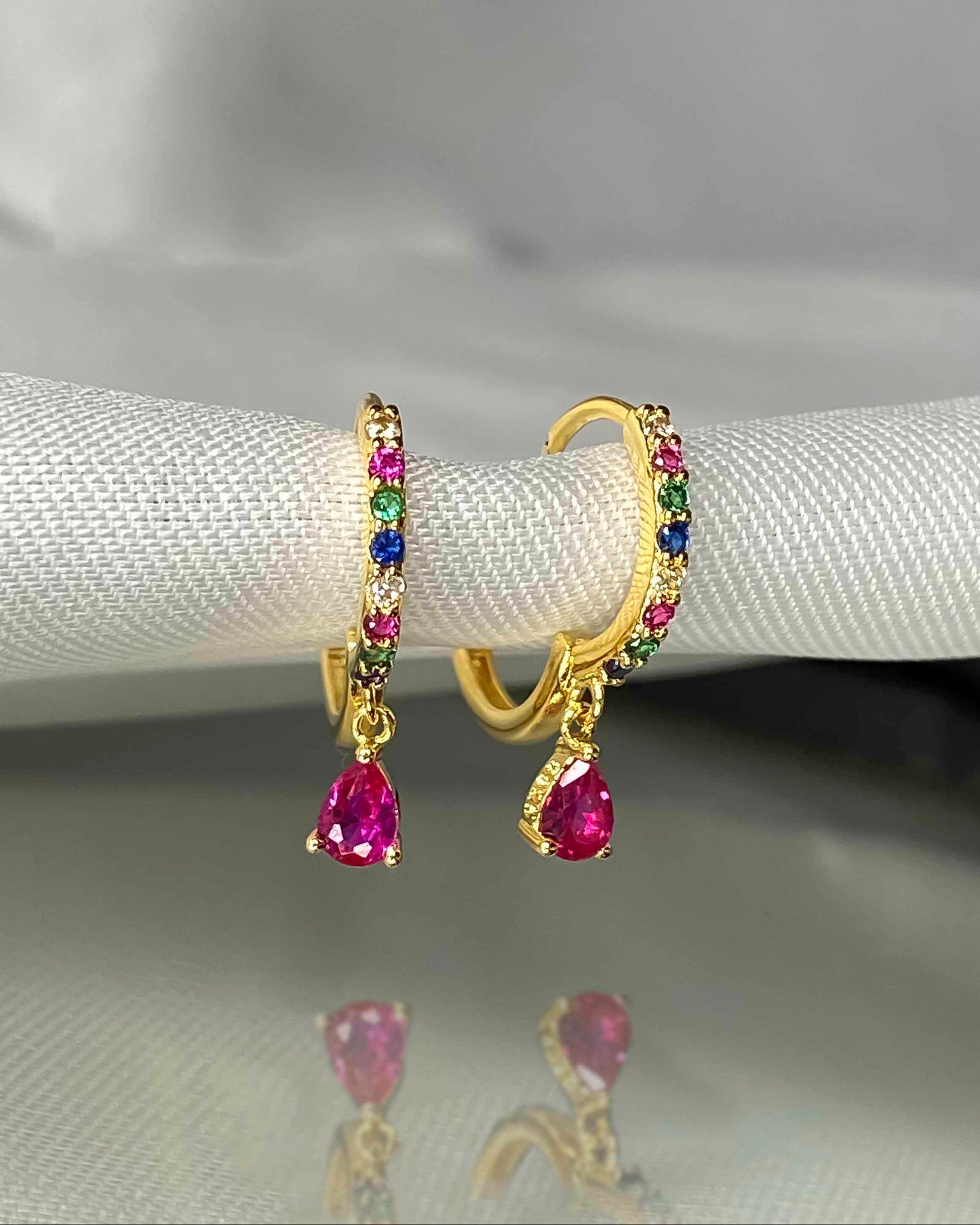 925 gold-plated sterling silver huggie hoop earrings with multicolored zirconia stones.