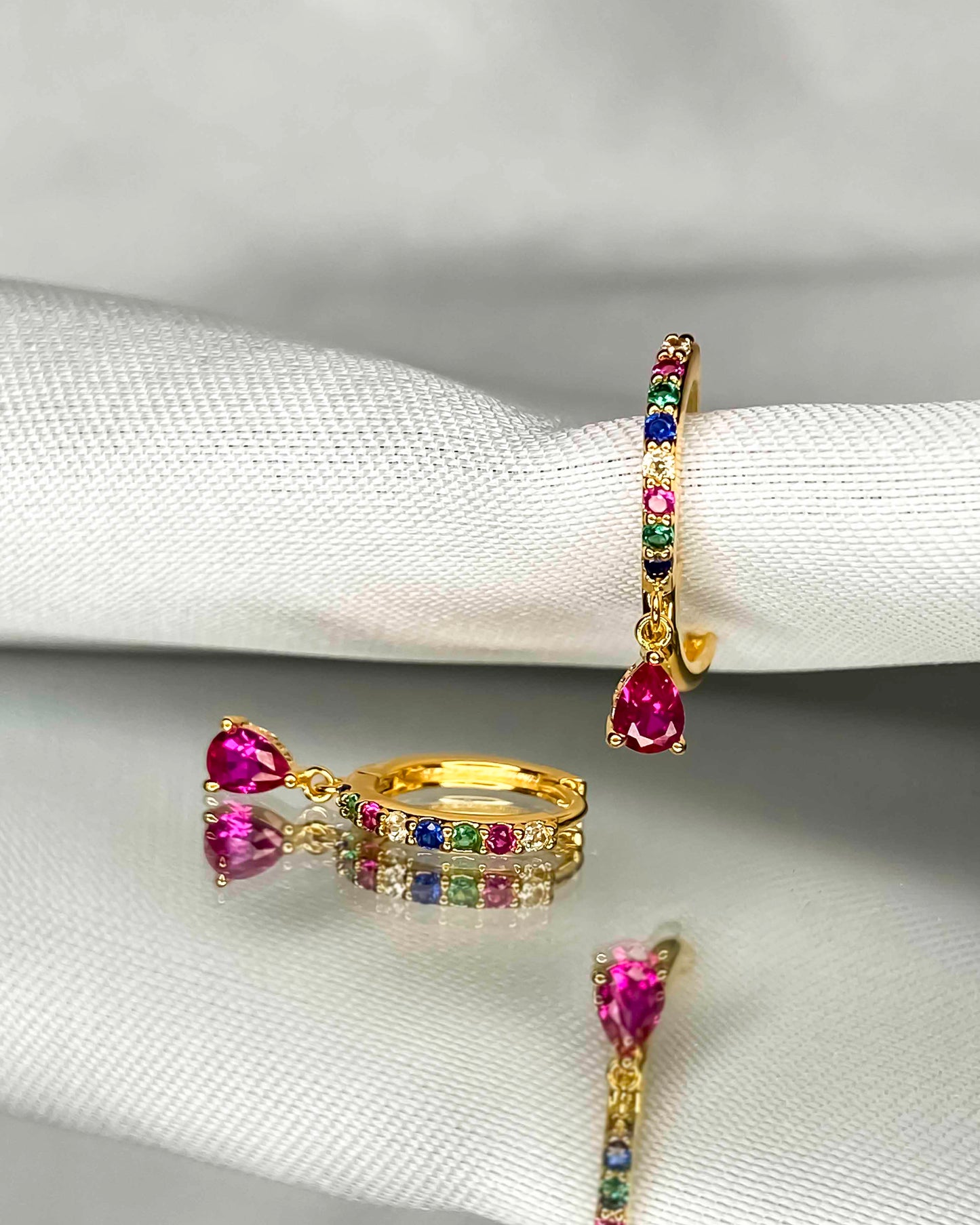 925 gold-plated sterling silver huggie hoop earrings with multicolored zirconia stones.