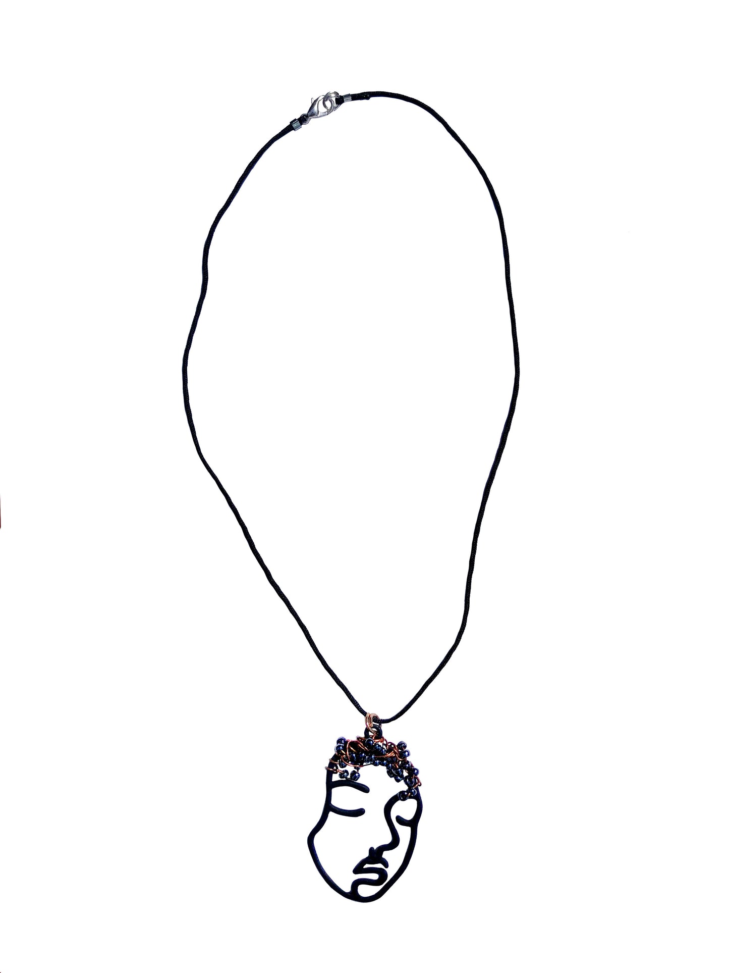 Hollowed out black face charm pendant necklace wire wrapped and beaded.