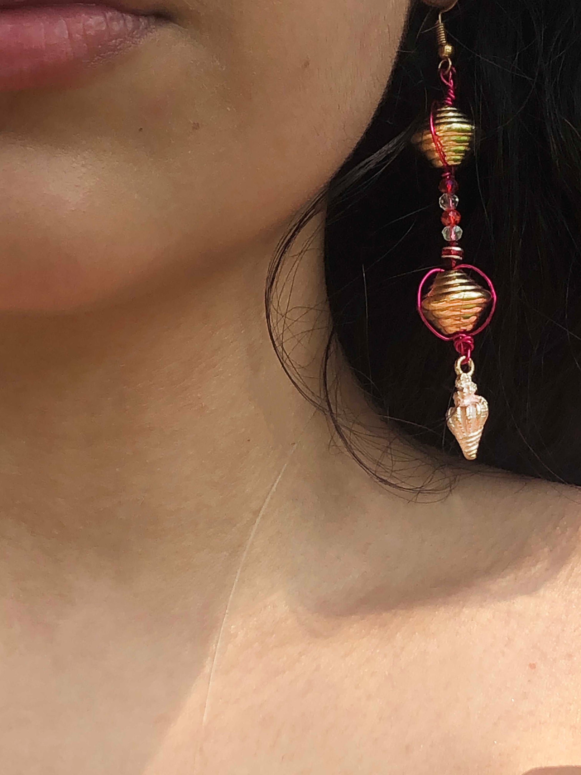 Handcrafted pink wire wrapped, beaded clear and red crystal earrings with golden and seashell charms.