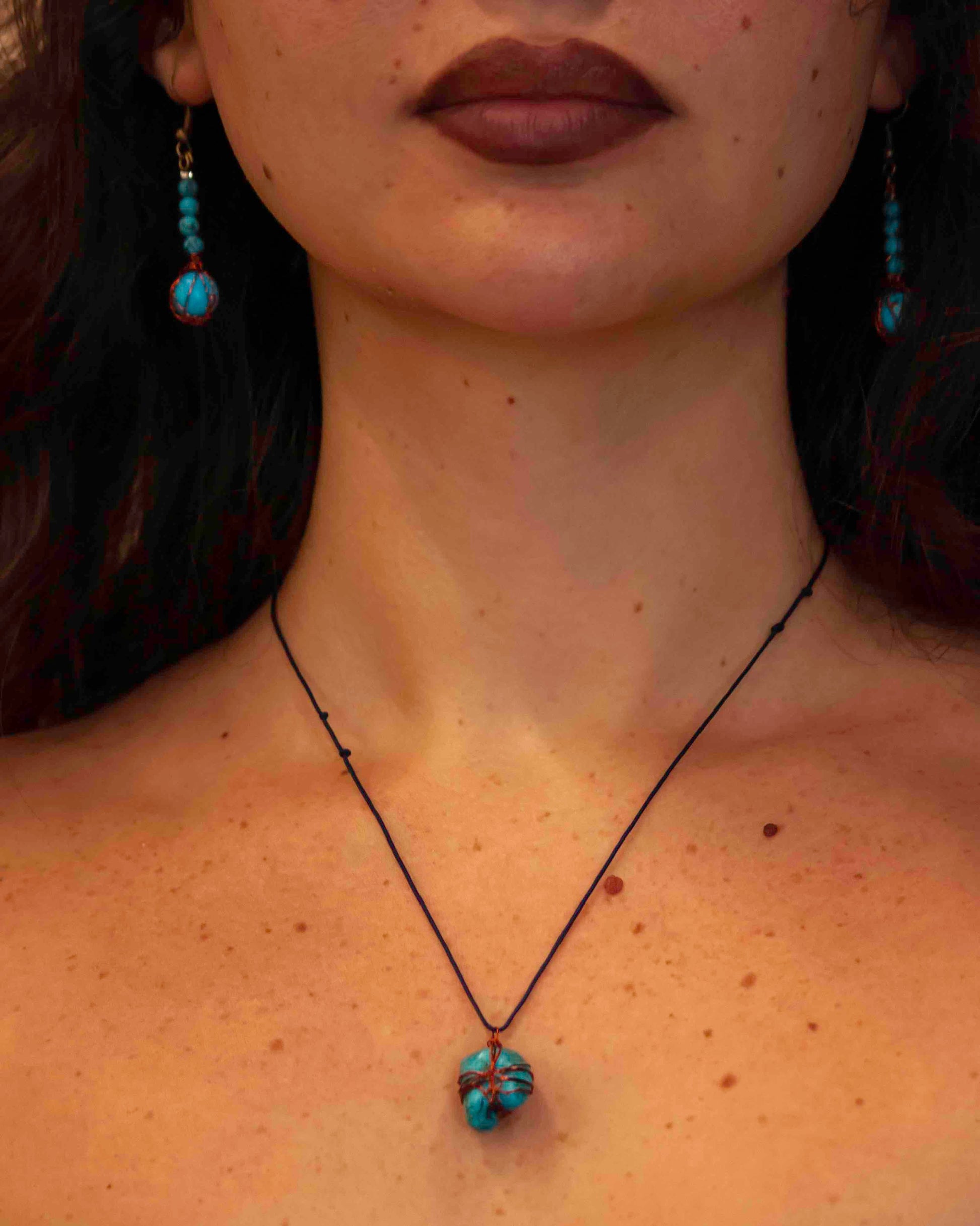 A pair of handcrafted wire-wrapped and beaded turquoise earrings, and matching pendant necklace.