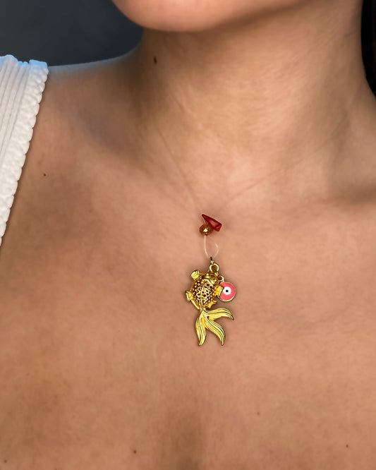 handmade goldfish charm pendant necklace with evil eye charm and crystal.