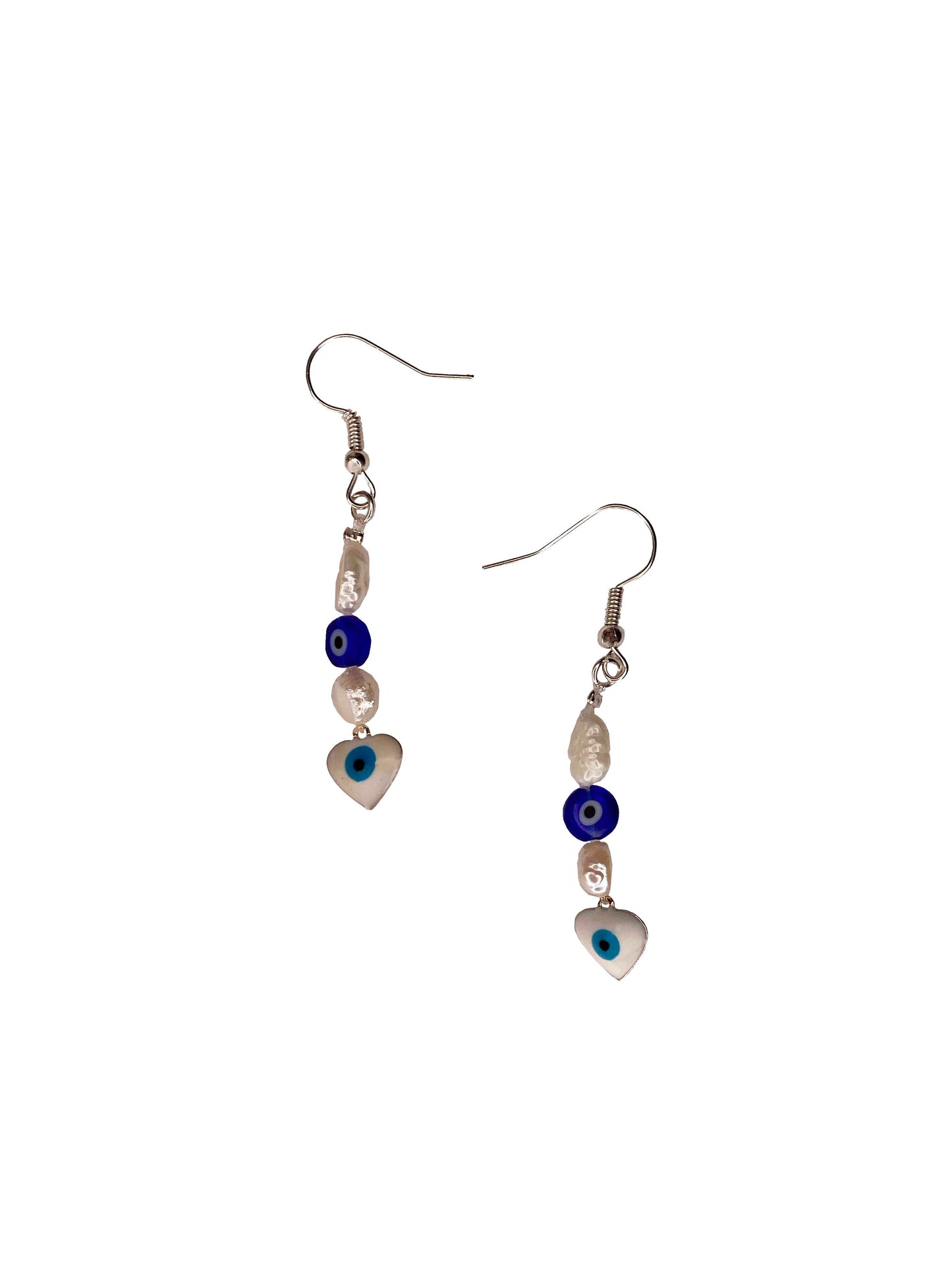 A pair of handmade freshwater pearl earrings with blue nazar amulet, and white evil eye charm.