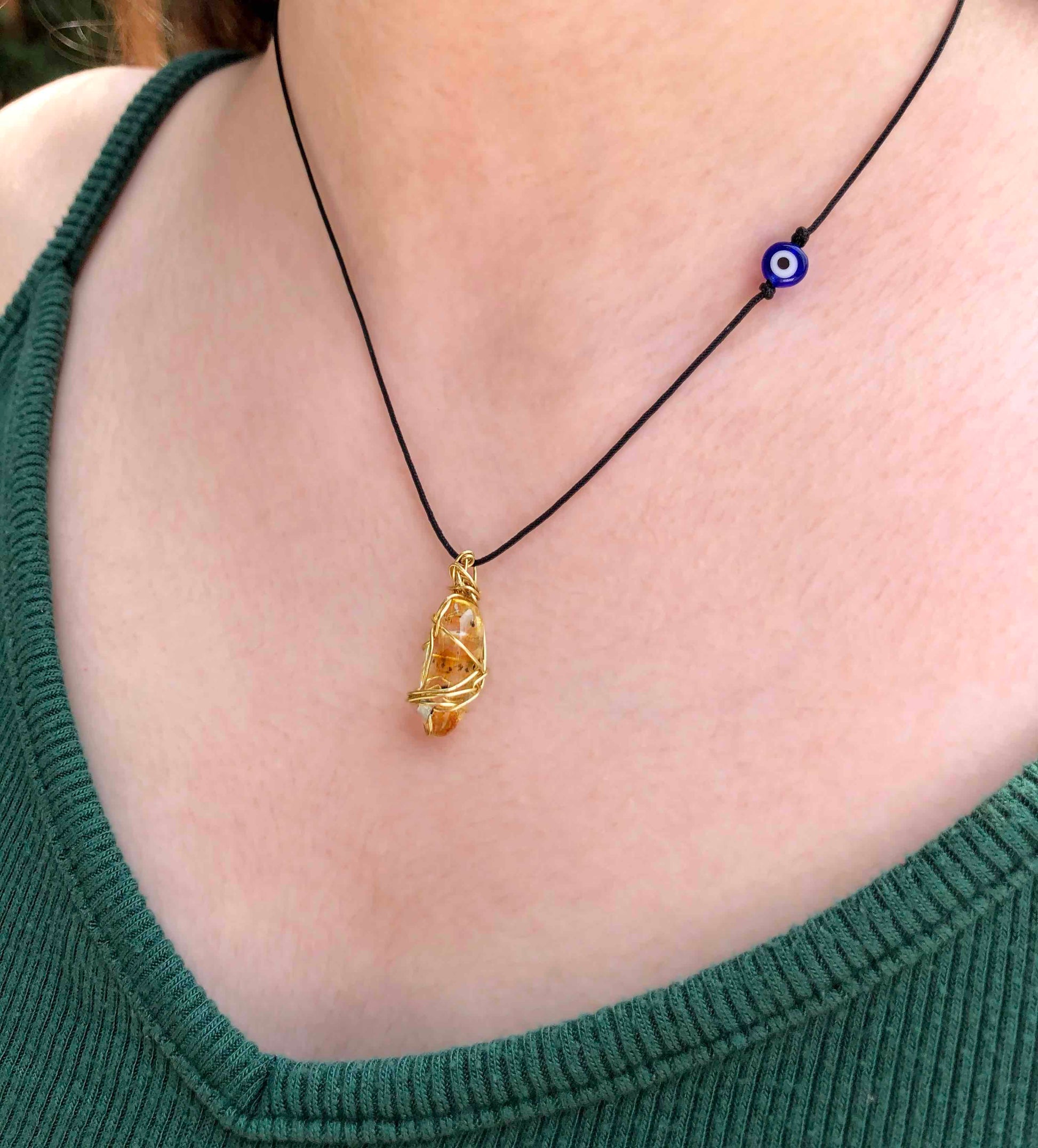 yellow tourmaline golden wire wrapped necklace with evil eye charm.
