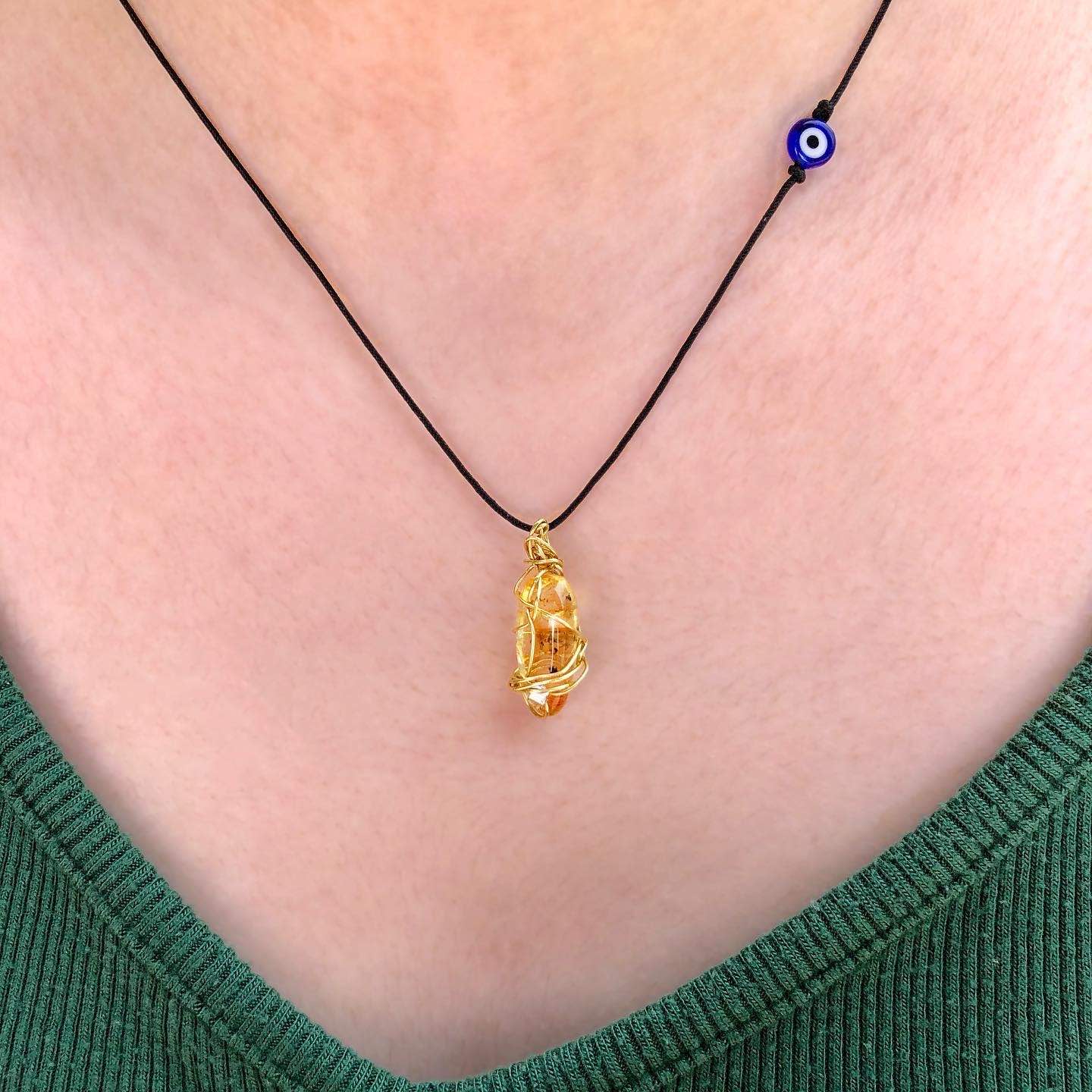yellow tourmaline golden wire wrapped necklace with evil eye charm.