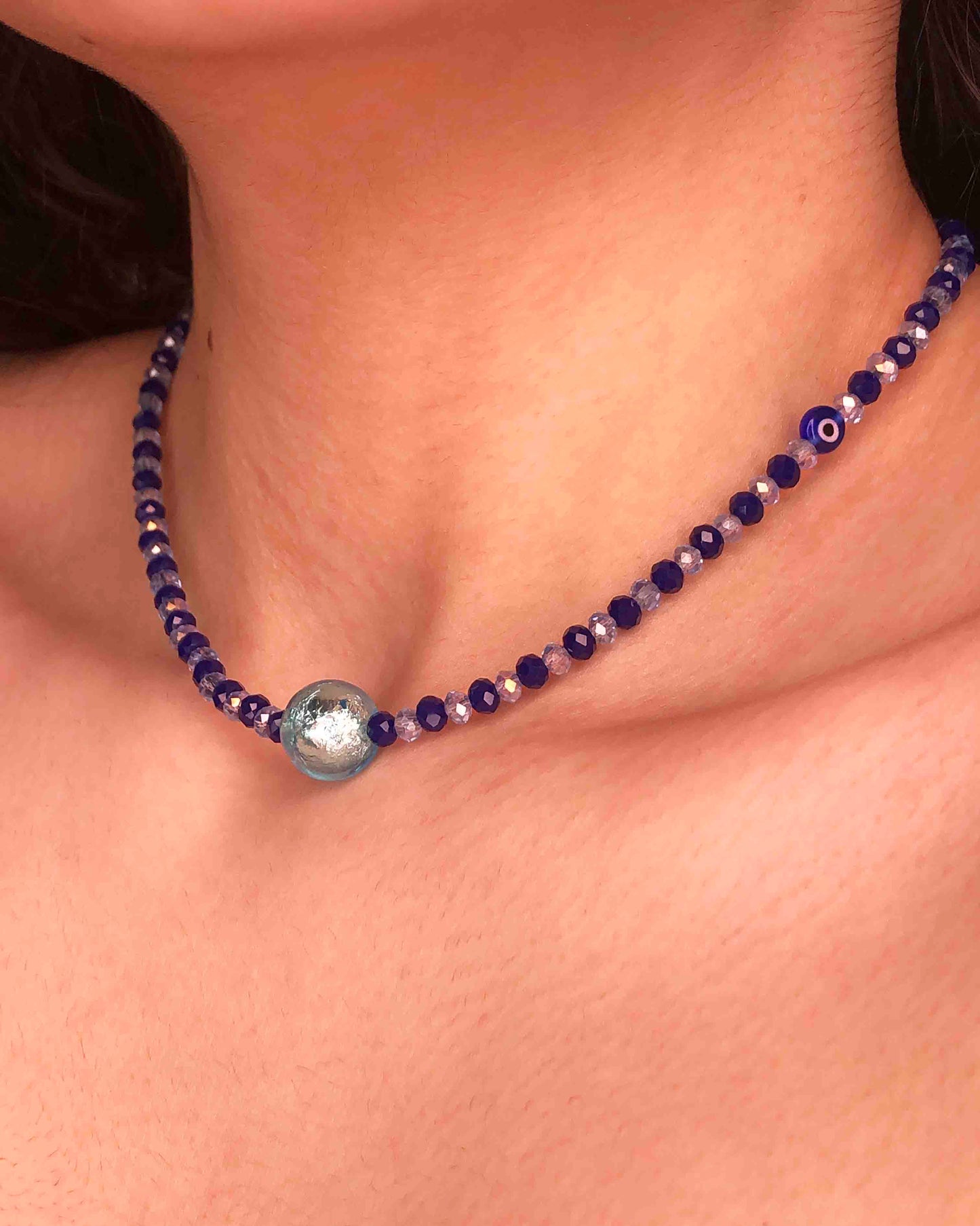 handcrafted blue crystal beaded necklace with an evil eye and paper mache charm