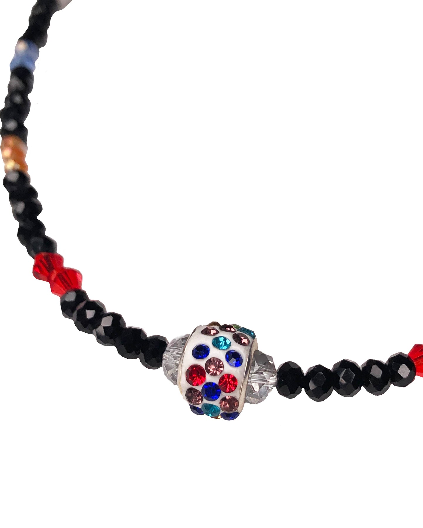 Handcrafted beaded crystal necklace made using black, blue, clear, orange, purple, and red crystal beads with white glass beads. At its center is a multicolor rhinestone charm.