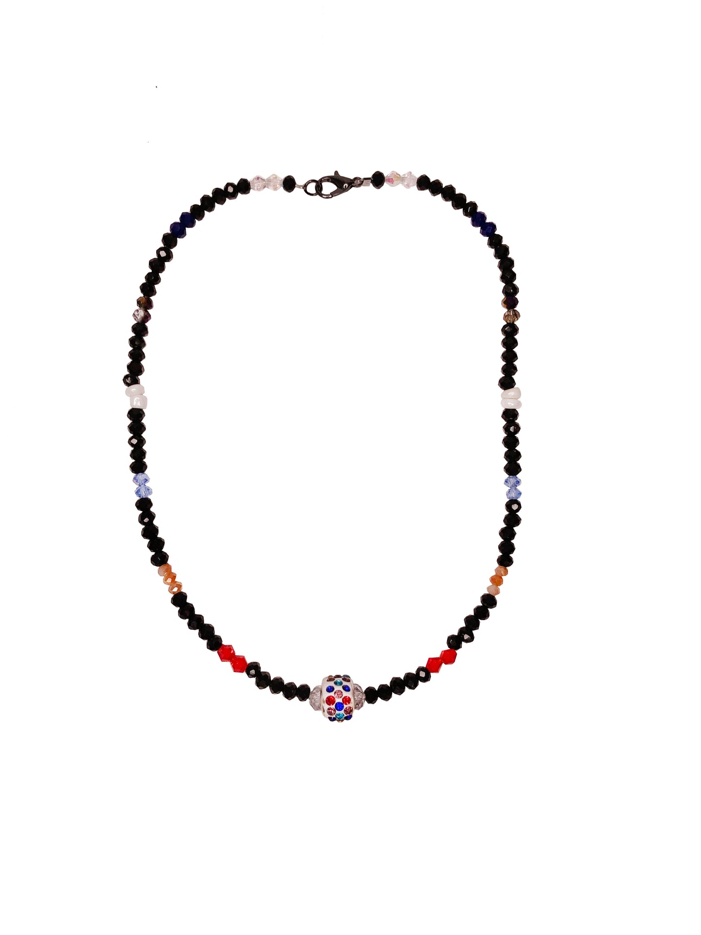 Handcrafted beaded crystal necklace made using black, blue, clear, orange, purple, and red crystal beads with white glass beads. At its center is a multicolor rhinestone charm.