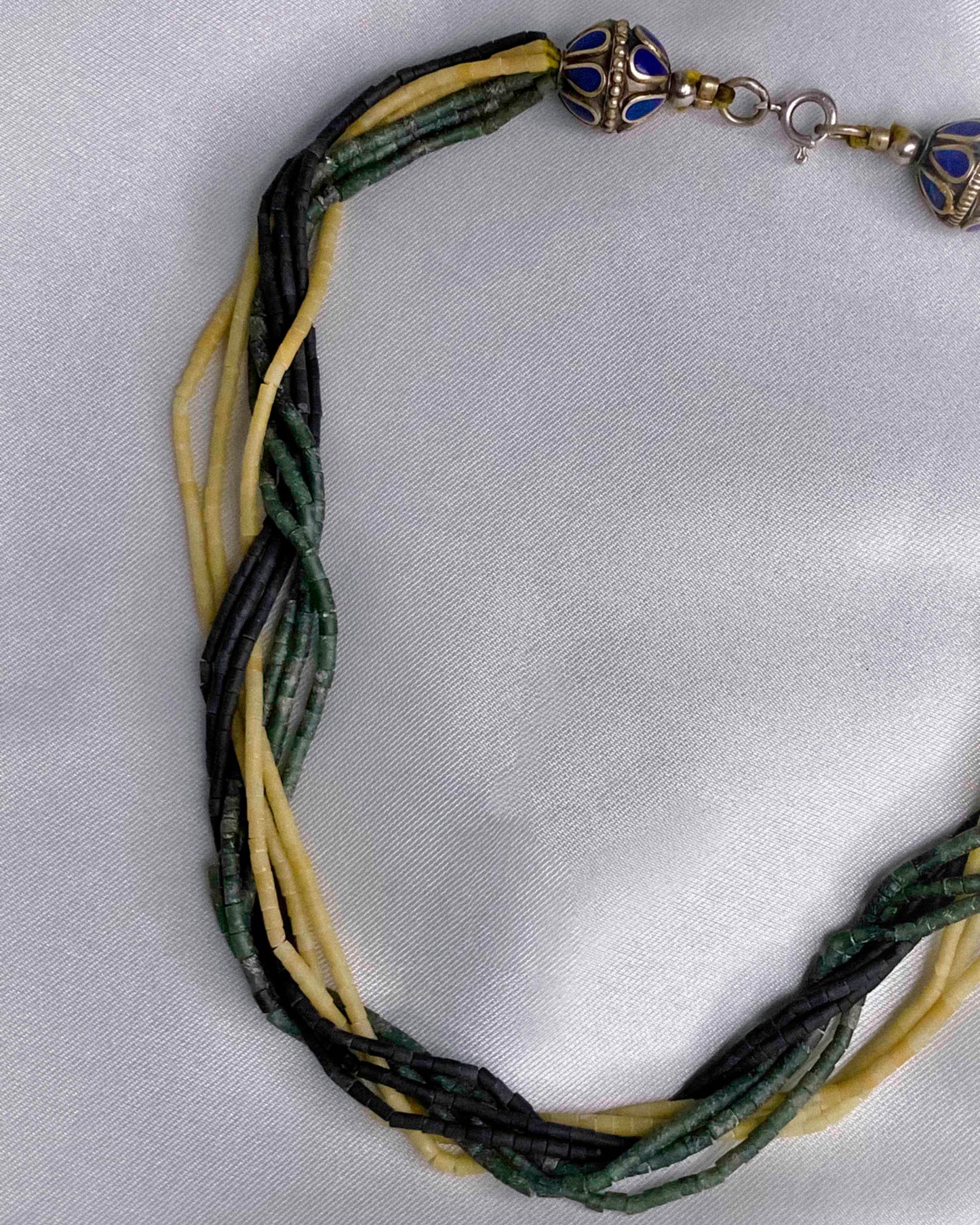 Vintage handmade beaded necklace made using granite stone beads, silver, and lapis lazuli.