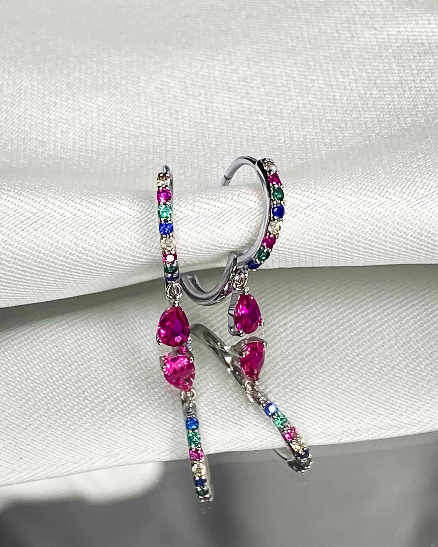 925 sterling silver huggie hoop earrings with multicolored zirconia stones.