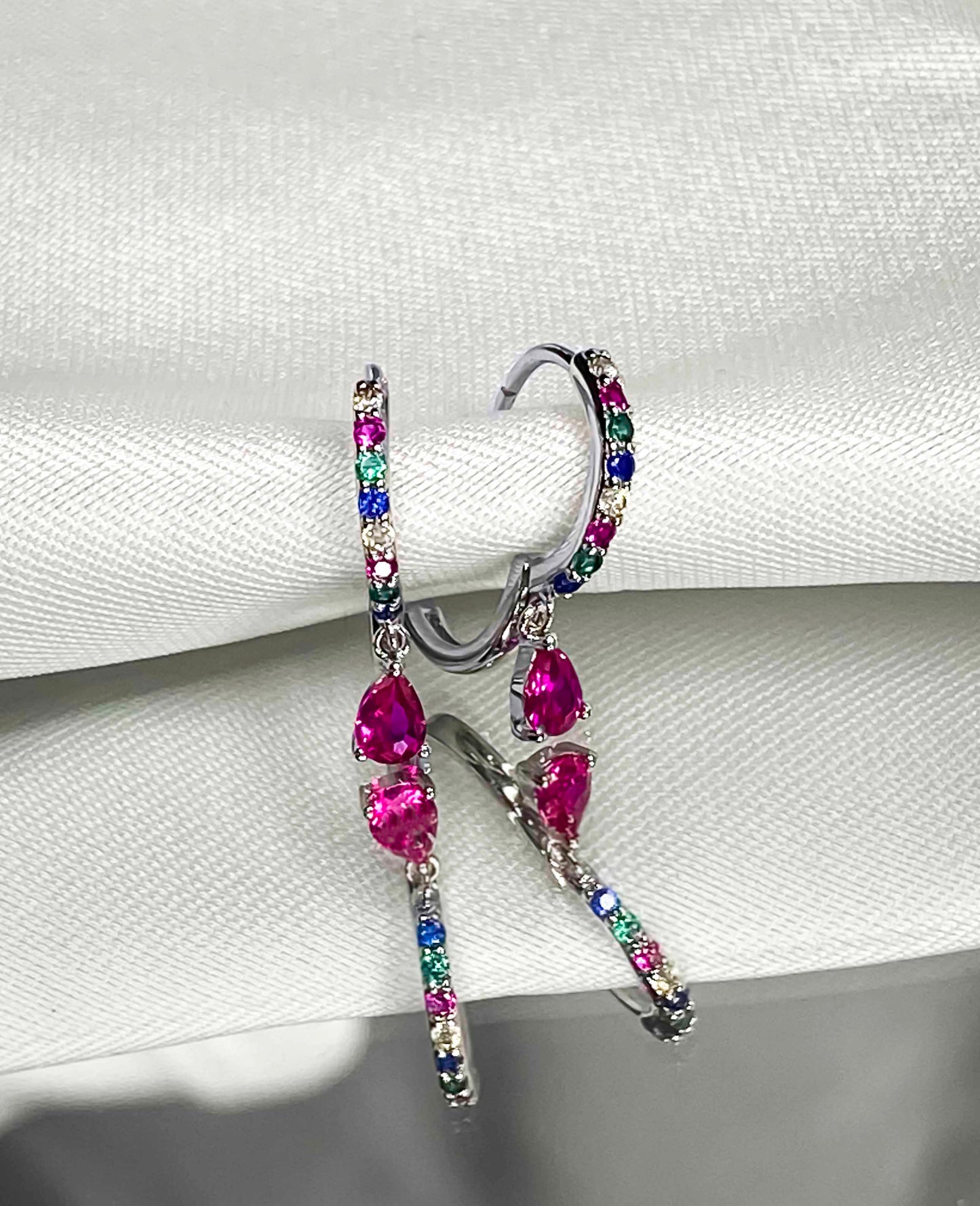 925 sterling silver huggie hoop earrings with multicolored zirconia stones.