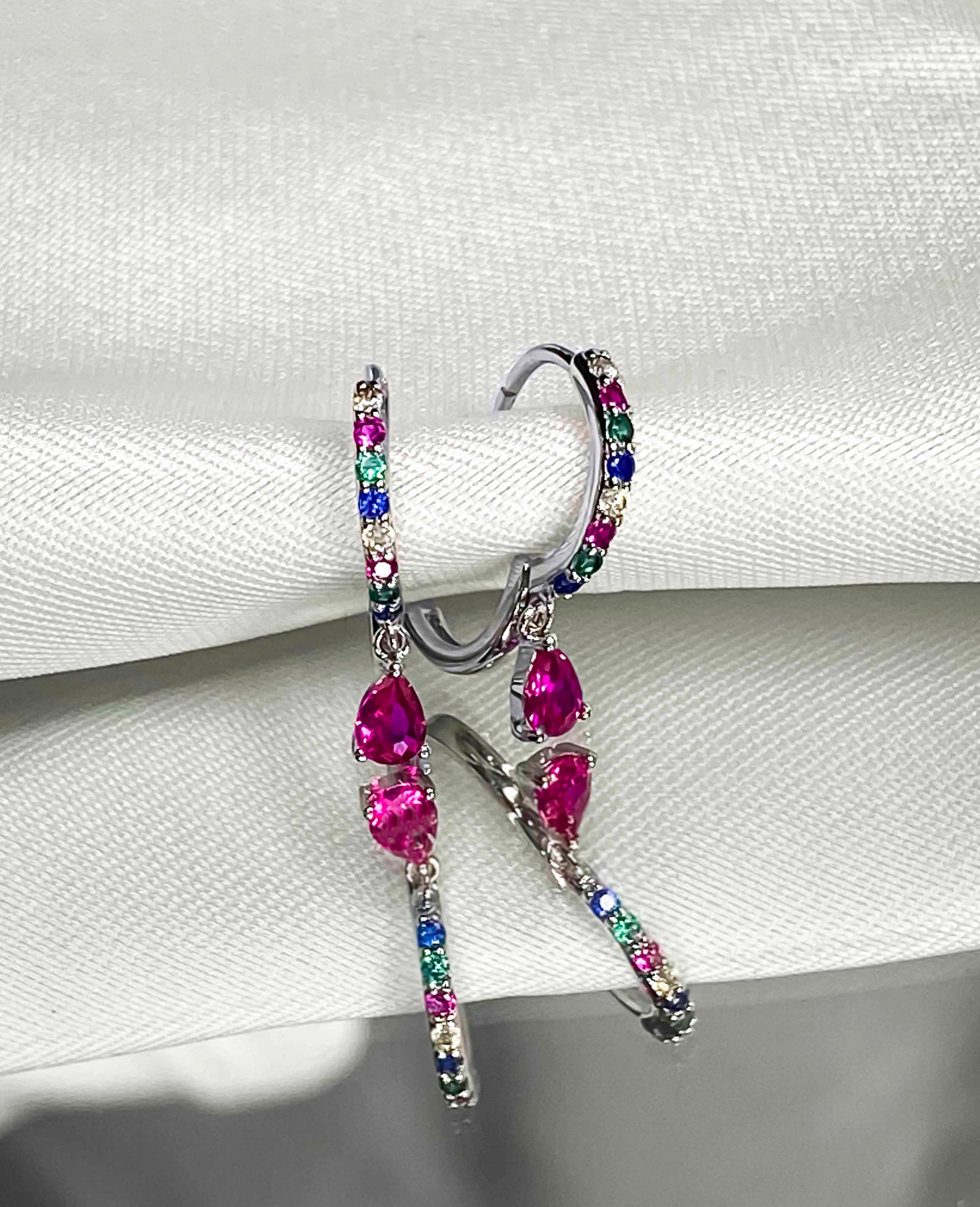 925 sterling silver huggie hoop earrings with multicolored zirconia stones.