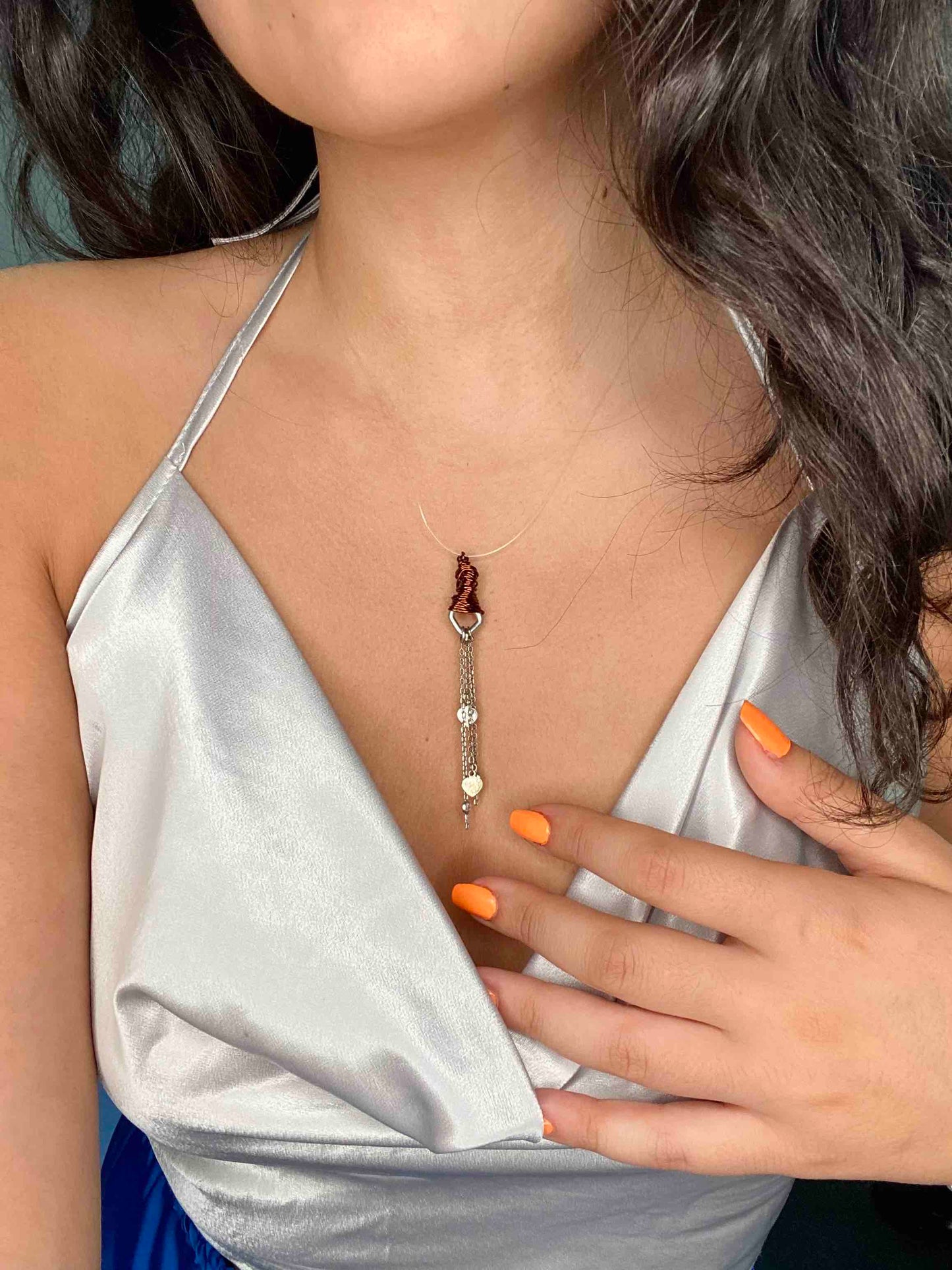 handcrafted bronze wire wrapped pendant with silver chains and heart charms.