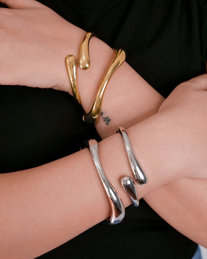 Gold and silver cuff bangle stacked with slim open bangle, modern abstract jewelry.