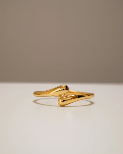 Open gold bangle, a modern balance of bold and minimal design.