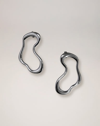 irregular hollow earrings, asymmetrical abstract earrings styled for evening wear, gold and silver finish
