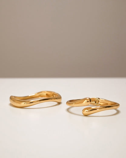 Gold cuff bangle stacked with slim open bangle, modern abstract jewelry