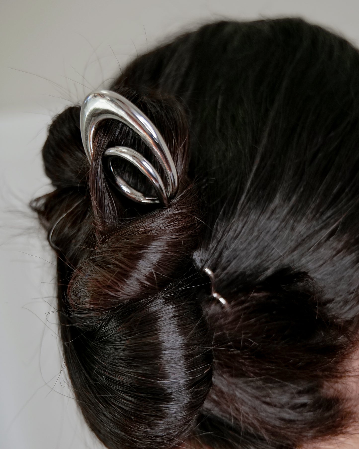 Sleek geometric hairpin styled in minimalist look, contemporary jewelry hair accessory