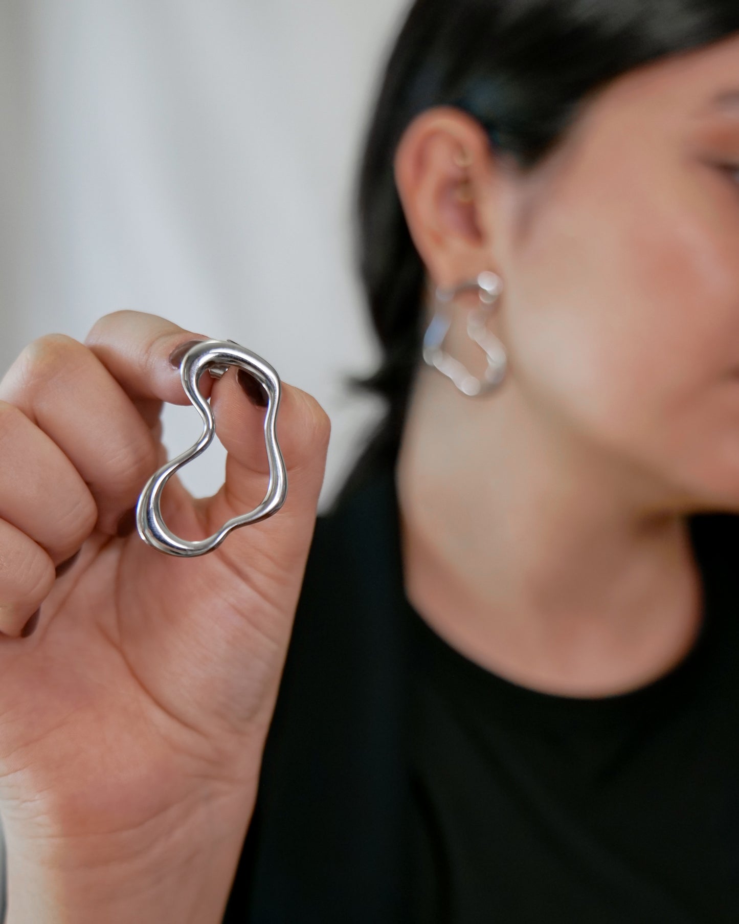 irregular hollow earrings, asymmetrical abstract earrings styled for evening wear, gold and silver finish