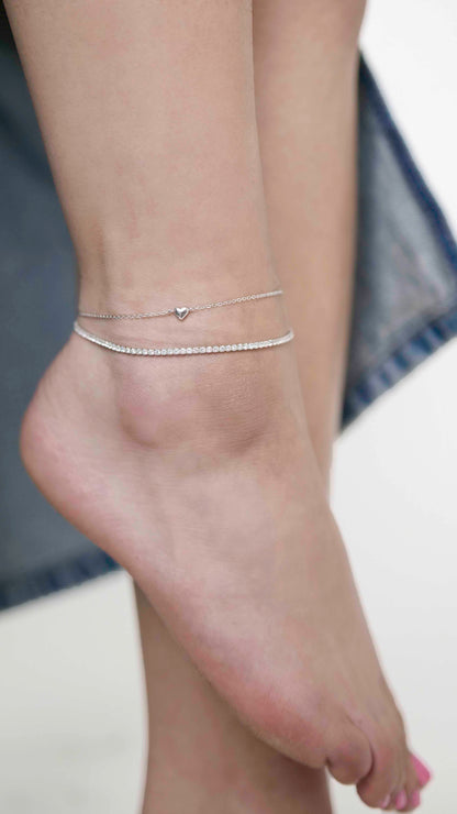 Sterling silver link chain anklet with a heart charm, and a Sterling silver zirconia stone tennis anklet.