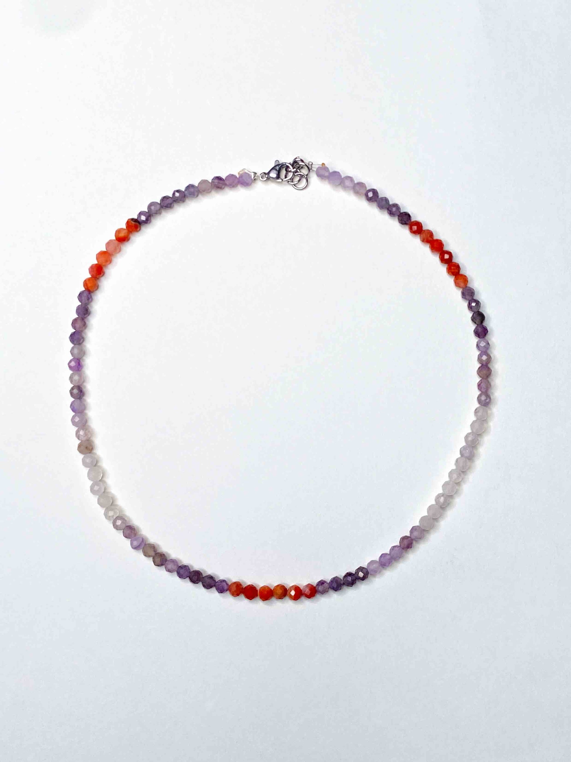 Handmade purple and orange mixed gemstone bead necklace with a sterling silver clasp.