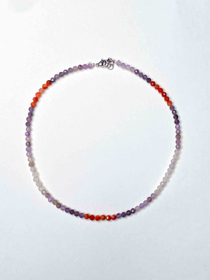 Handmade purple and orange mixed gemstone bead necklace with a sterling silver clasp.