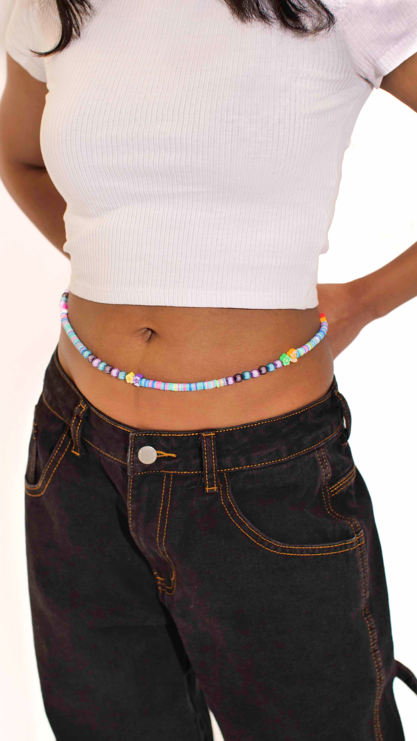 Handmade beaded belly chain made using multicolor flat rubber beads, flower and butterfly charms, and Discoball-like beads.