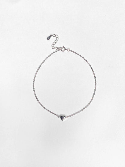 Sterling silver link chain anklet with a heart charm.