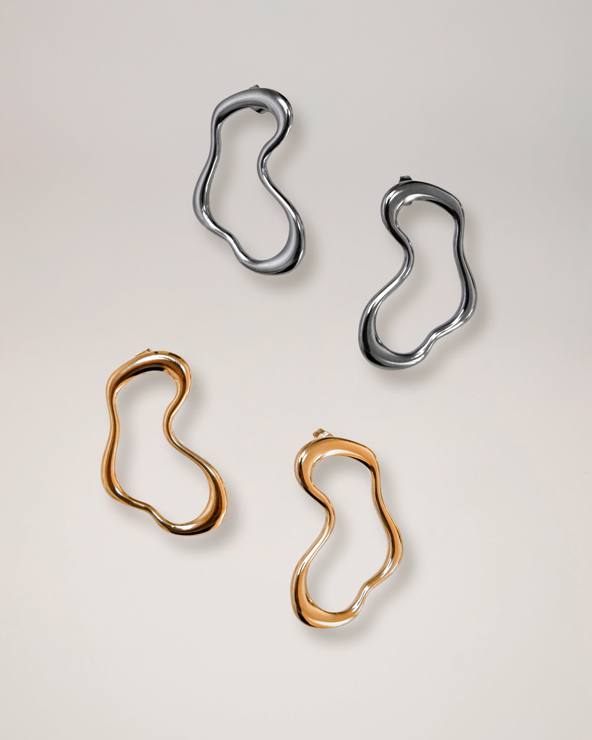 irregular hollow earrings, asymmetrical abstract earrings styled for evening wear, gold and silver finish
