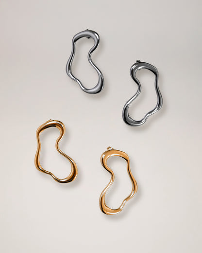 irregular hollow earrings, asymmetrical abstract earrings styled for evening wear, gold and silver finish
