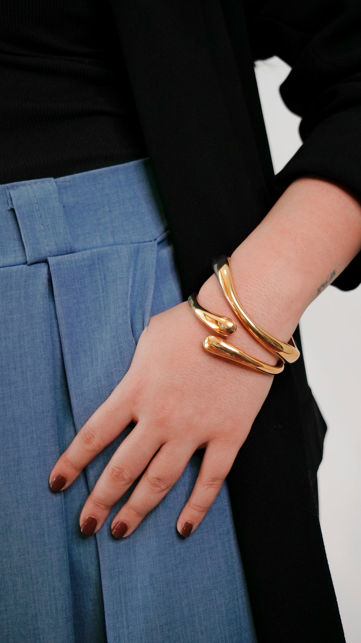 Gold cuff bangle stacked with slim open bangle, modern abstract jewelry