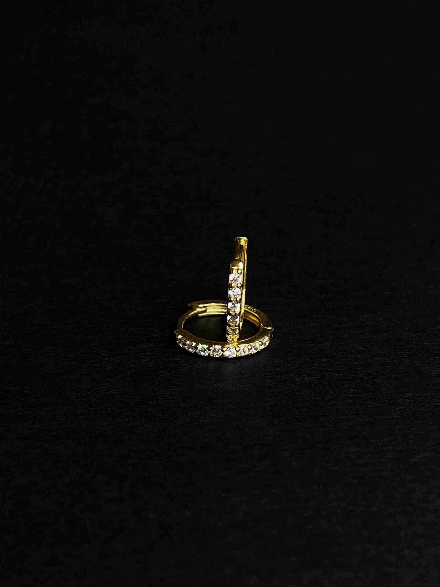Gold-plated hoop earrings with zirconia stones.