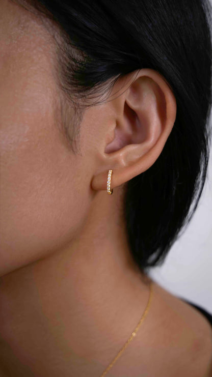 Gold-plated hoop earrings with zirconia stones.