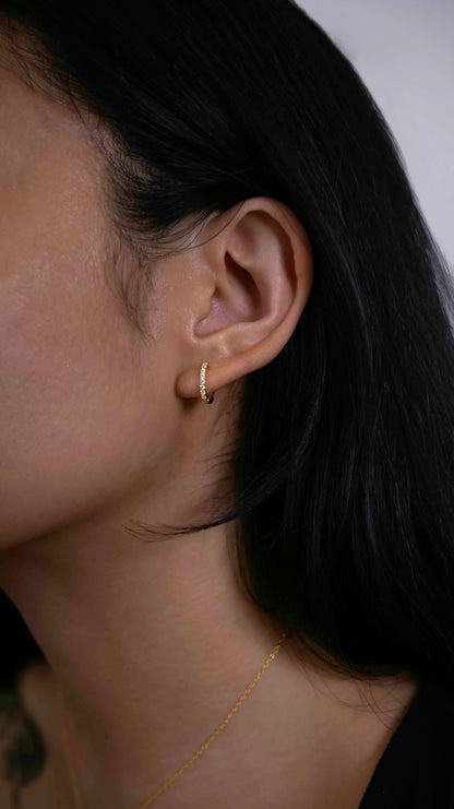 Gold-plated hoop earrings with zirconia stones.