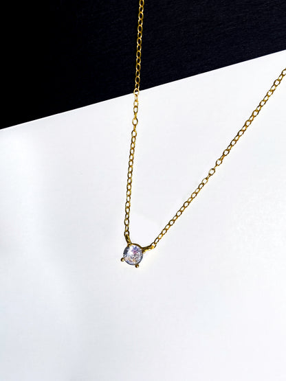 Gold-plated chain link necklace with zirconia stones.